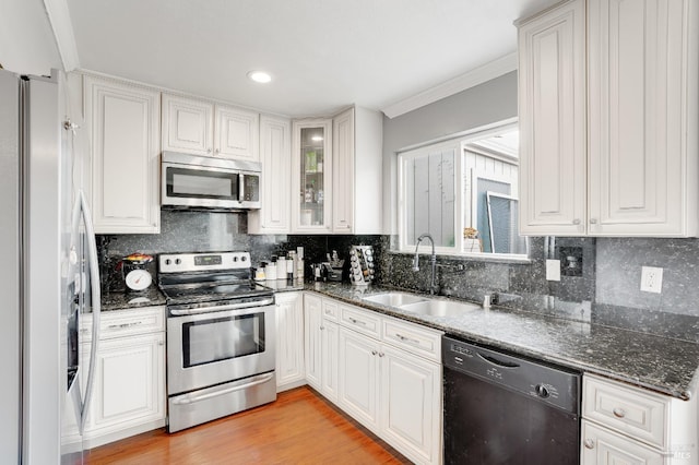 kitchen with appliances with stainless steel finishes, sink, and white cabinets