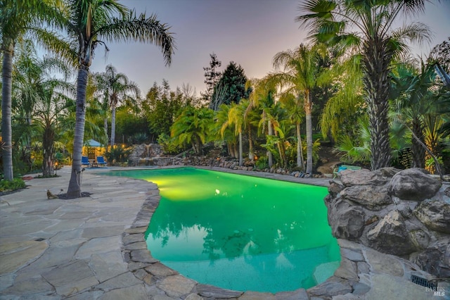 view of pool at dusk