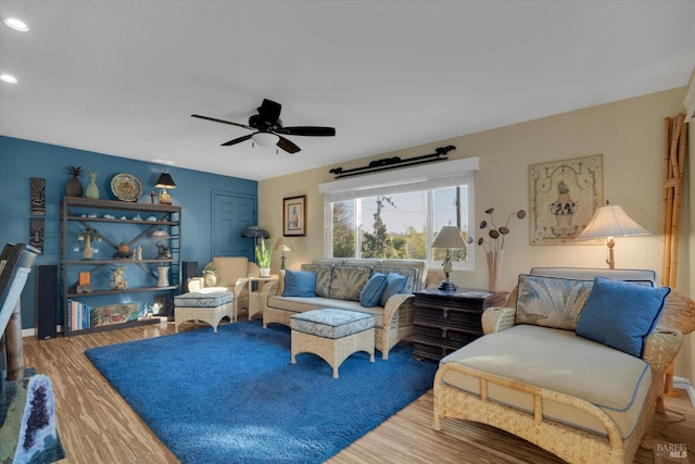 living room featuring ceiling fan and wood-type flooring