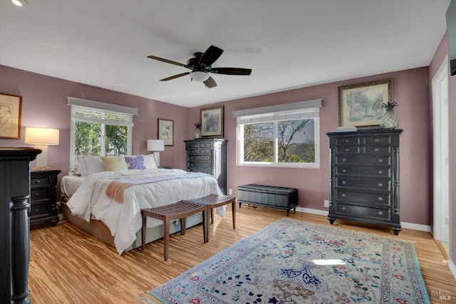 bedroom with ceiling fan and light hardwood / wood-style floors