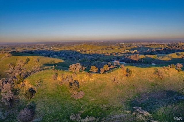 aerial view at dusk featuring a rural view