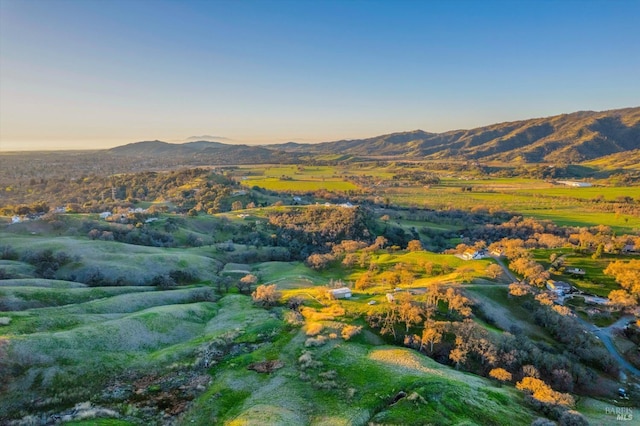 aerial view at dusk featuring a mountain view