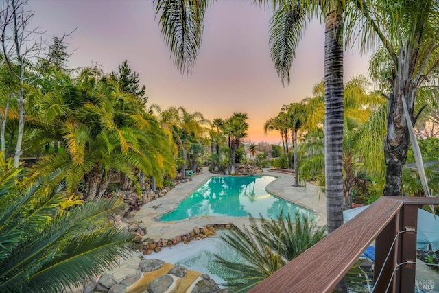 view of pool at dusk