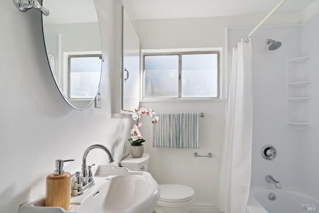 full bath with shower / bath combination with curtain, a sink, and toilet