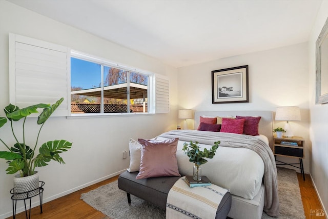 bedroom featuring baseboards and wood finished floors