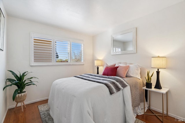 bedroom featuring wood finished floors and baseboards