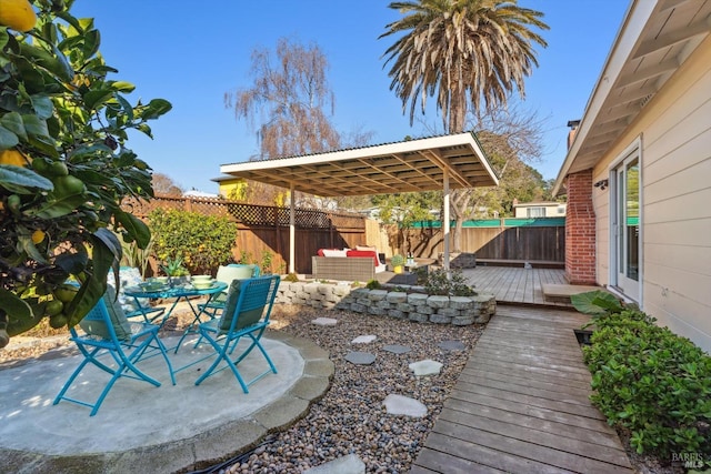 view of patio / terrace featuring outdoor dining space, outdoor lounge area, a deck, and a fenced backyard