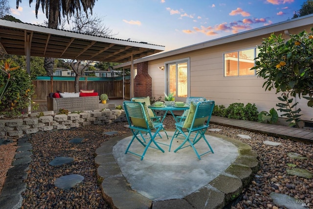 view of patio featuring outdoor dining space and fence