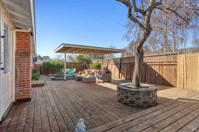 deck with outdoor lounge area and a fenced backyard