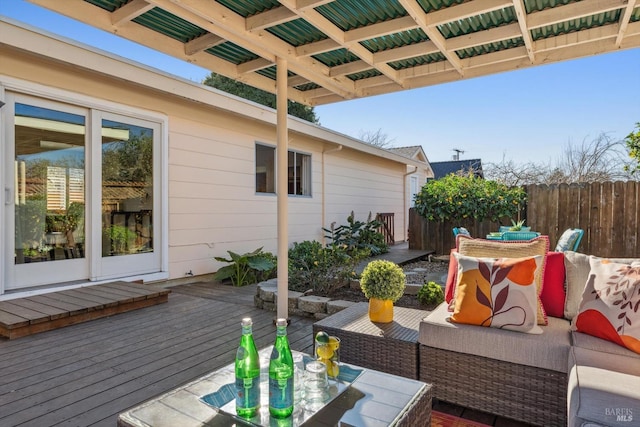 deck with an outdoor hangout area, fence, and outdoor dining area