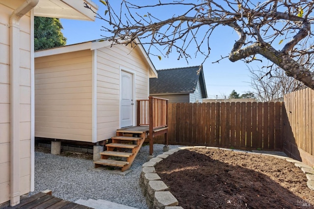 view of yard with fence and an outdoor structure