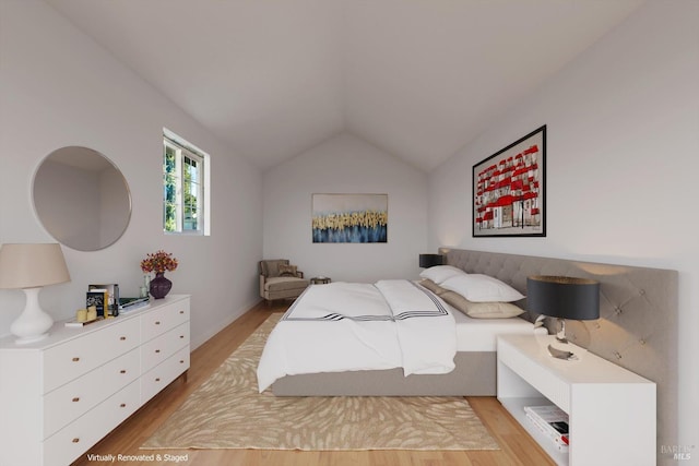 bedroom featuring light wood-type flooring and vaulted ceiling