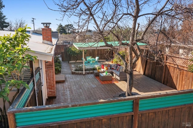 deck featuring outdoor lounge area and a fenced backyard