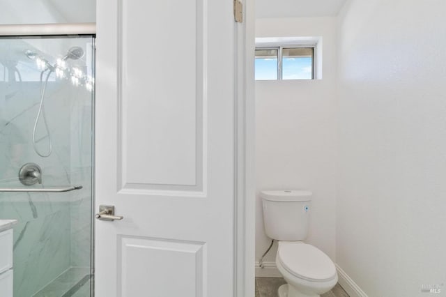 bathroom with an enclosed shower and toilet