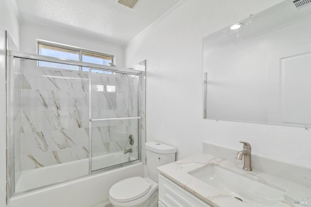 full bathroom featuring toilet, a textured ceiling, vanity, ornamental molding, and enclosed tub / shower combo