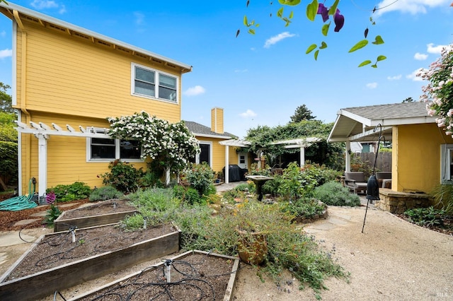 back of house with a pergola