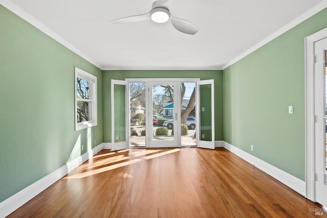 spare room featuring ceiling fan, ornamental molding, and wood-type flooring