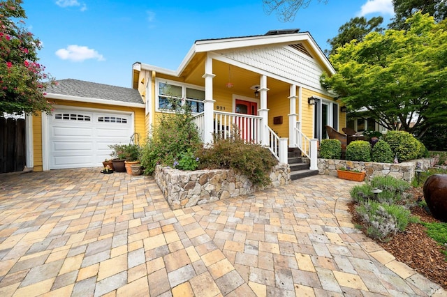 view of front of property featuring a garage and covered porch