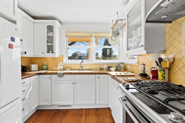 kitchen with white cabinetry, white appliances, tasteful backsplash, and wall chimney range hood