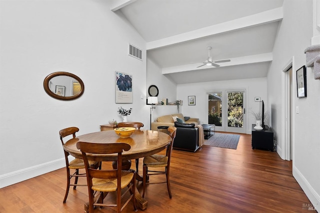 dining space with ceiling fan, dark hardwood / wood-style floors, high vaulted ceiling, and beam ceiling