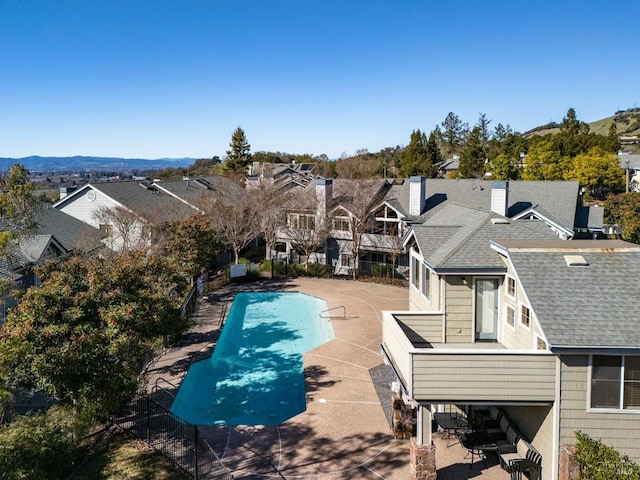 view of pool with a residential view, a patio area, and a fenced in pool