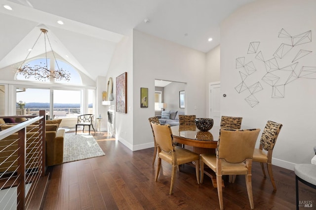 dining space featuring baseboards, high vaulted ceiling, recessed lighting, and dark wood-style flooring