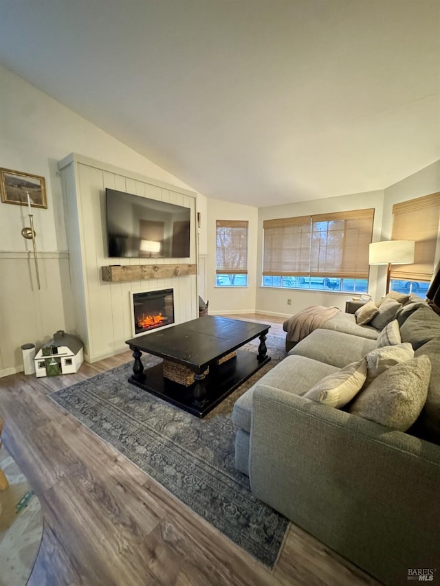 living room featuring lofted ceiling and wood-type flooring