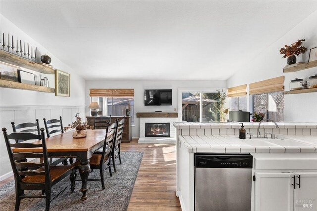 dining space featuring vaulted ceiling and hardwood / wood-style floors