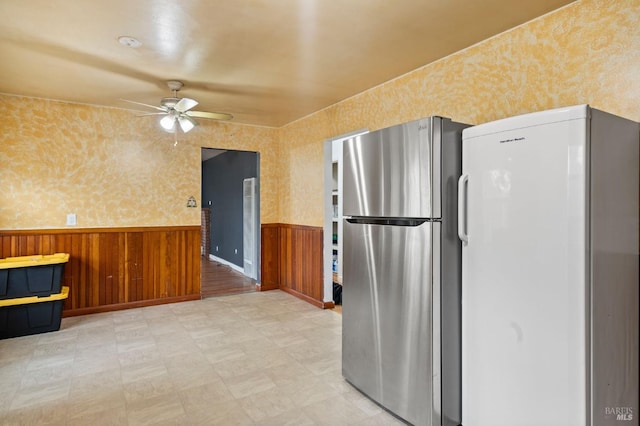 kitchen featuring stainless steel fridge, ceiling fan, and white refrigerator