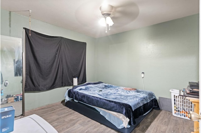 bedroom with hardwood / wood-style flooring and ceiling fan