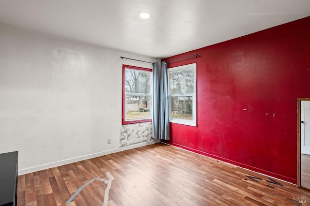 spare room featuring wood-type flooring