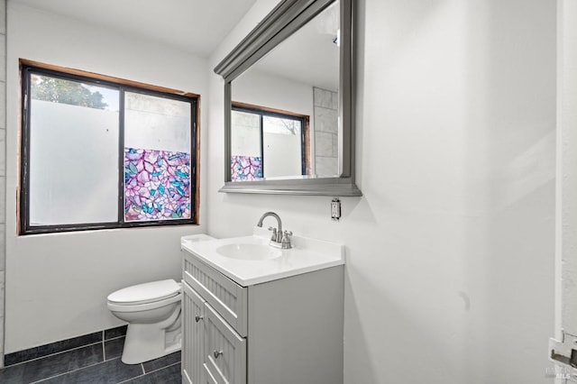 bathroom featuring tile patterned floors, vanity, and toilet