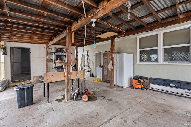 miscellaneous room featuring washer / dryer and concrete floors