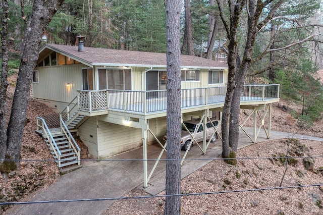 back of house featuring a carport