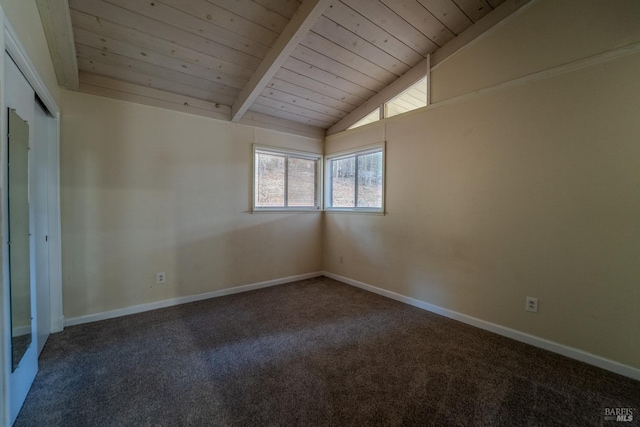 spare room featuring lofted ceiling with beams, wooden ceiling, and carpet flooring