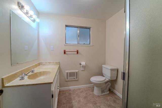 bathroom featuring vanity, tile patterned floors, and toilet