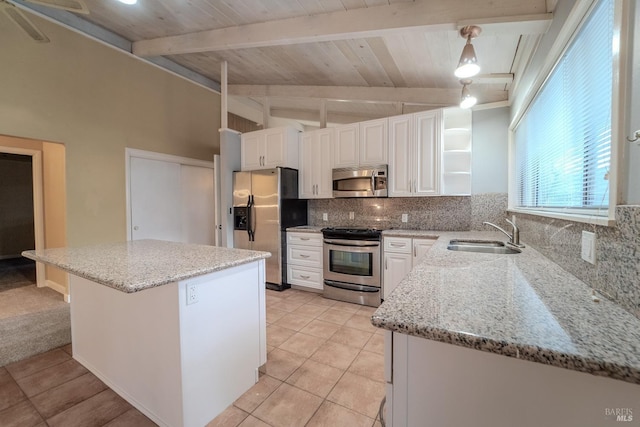 kitchen with sink, white cabinetry, backsplash, hanging light fixtures, and stainless steel appliances