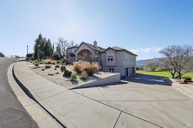 view of front of home with a garage and a mountain view