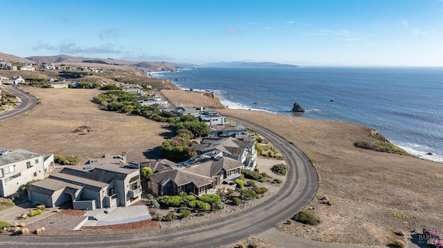 birds eye view of property with a water and mountain view