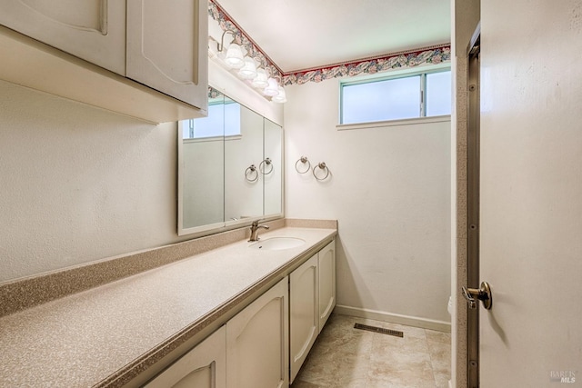 bathroom with plenty of natural light and vanity