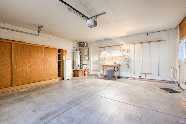 garage with a garage door opener and water heater