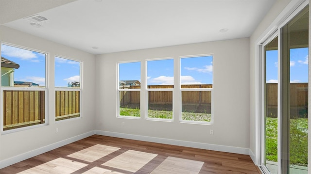 unfurnished sunroom featuring visible vents