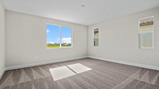 spare room with carpet flooring and baseboards