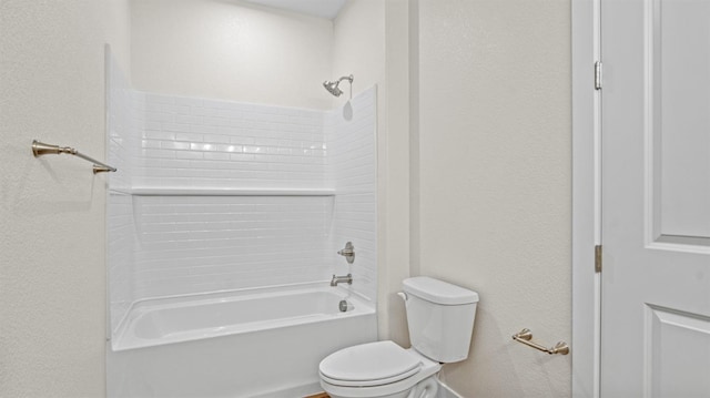 bathroom featuring shower / washtub combination and toilet