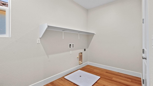 laundry room with laundry area, washer hookup, wood finished floors, and baseboards