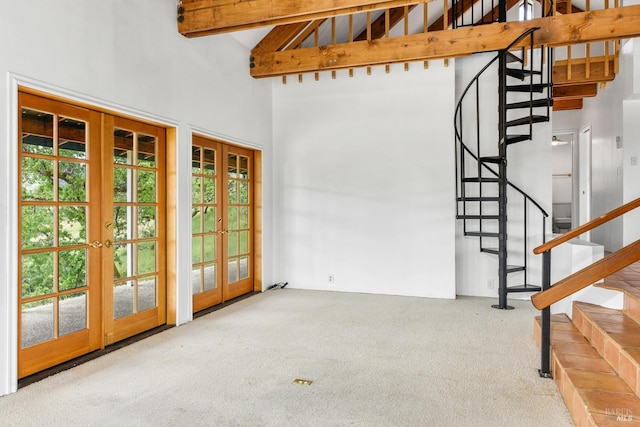 interior space with beamed ceiling, carpet, high vaulted ceiling, and french doors