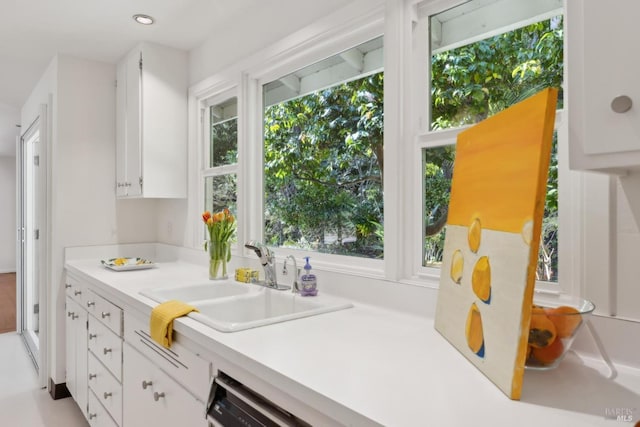 kitchen featuring white cabinetry and sink