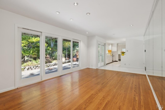 unfurnished living room featuring light wood-type flooring