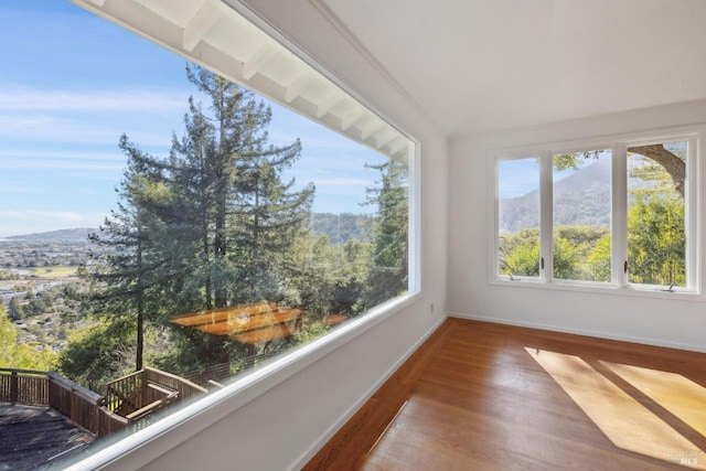 unfurnished sunroom featuring a mountain view