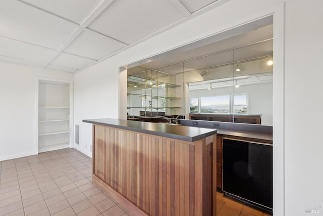 kitchen with light tile patterned floors, built in features, and rail lighting